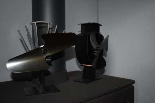 Two stove fans being compared with different number of blades
