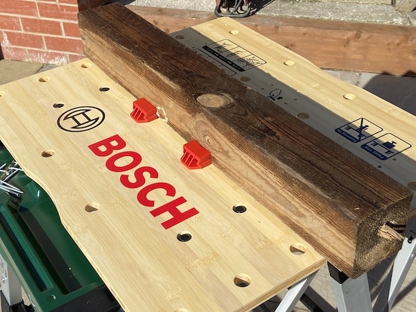 Bosch PWB 600 Portable Work Bench holding large piece of timber with dog clamps