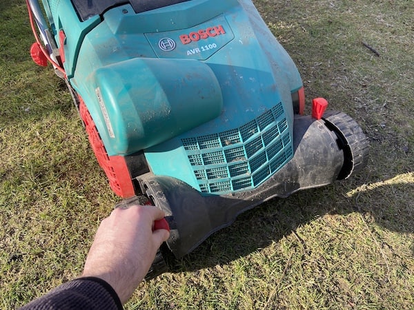 Easy to adjust the working height of the Verticutter Lawnraker using the two handles to left and lower the deck