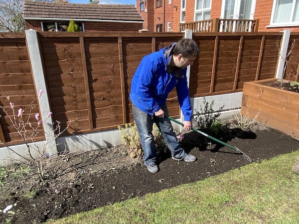 Raking soil level to get an idea of much topsoil if needed