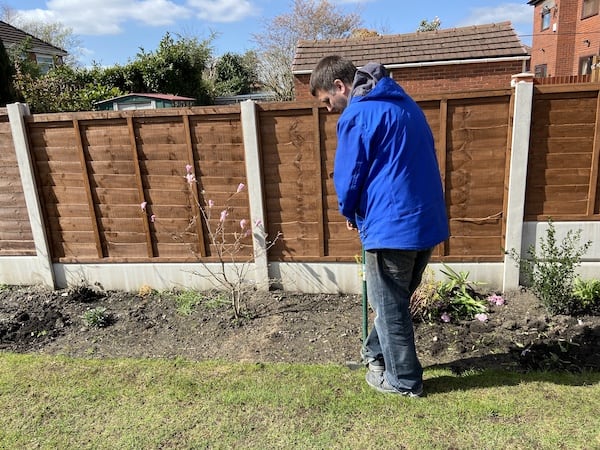 Using lawn edger to make edge of lawn as straight as possible before extending lawn
