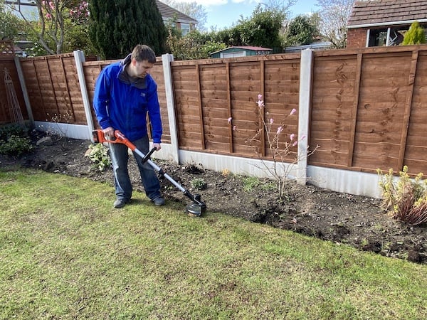 Strimming lawn to make it near and tidy to make it easier to lay new turf right up to it