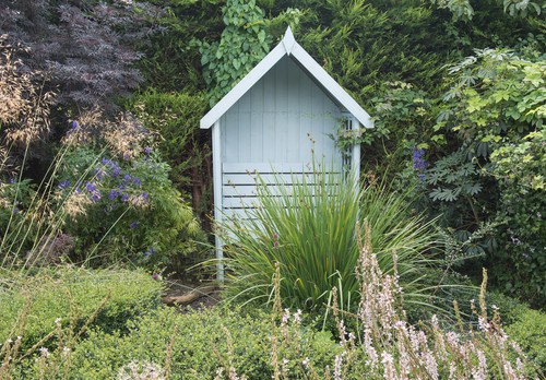 More affordable arbour seat for relaxing with a solid back and lattice sides