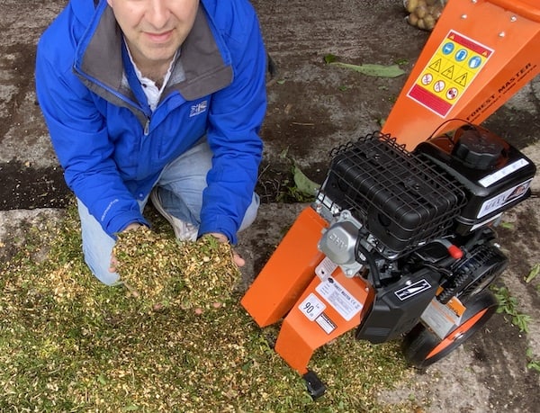 Close up of thick branches, conifers, weeds and other green waste all shredded