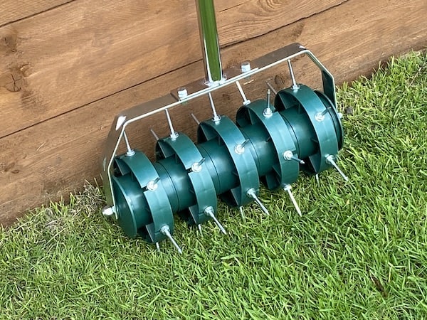 Greenkey 30cm Rolling Lawn Aerator close up showing the 5cm long 30 spikes that penetrate the lawn