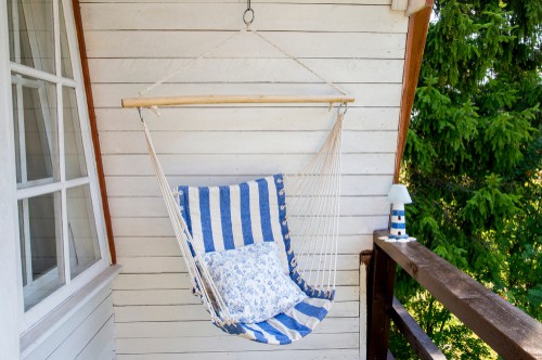 Hanging hammock chair hanging from outdoor porch