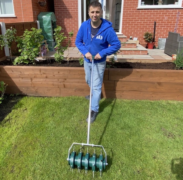 Manual roller lawn aerator being tested