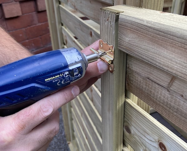 screwing latches onto Rowlinson Triple Bin store