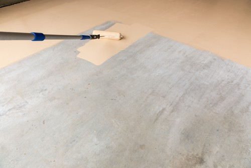 Using a long roller can make painting a garage floor much easier