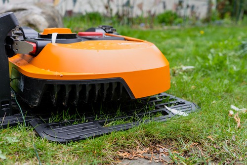 Robot lawn mower recharging on docking station which is returns to when running low automaticlly