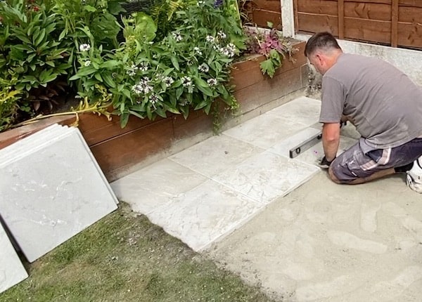 Finally installing the flags on top of the bed of dry mix and you spirit level to make sure its level