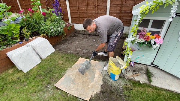 Mixing grit sand and cement at a mix of 1 part cement to 6 parts grit sand to make dry mix base