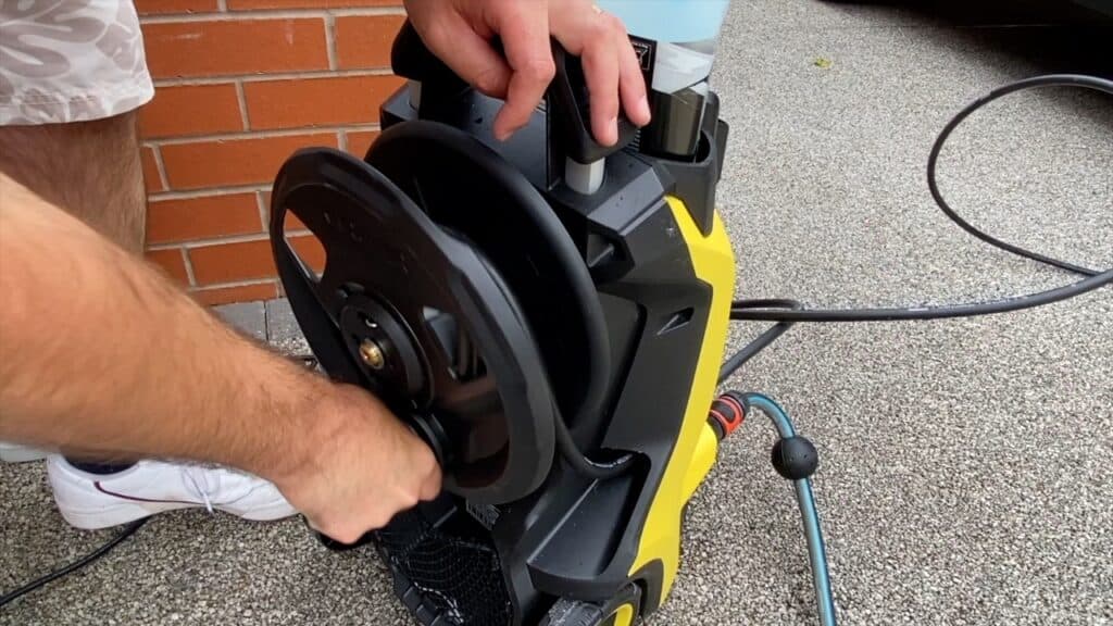 Rewinding hose reel after cleaning car