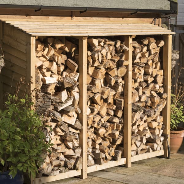 Using a log store to store firewood for 12-24 months to season the wood so the moisture content is below 20%