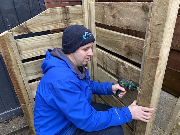 Attaching back post to first back panel before attaching the next back panel to the other side of the post