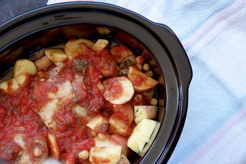 Chicken and fresh vegetables cooking in a slow electric cooker.