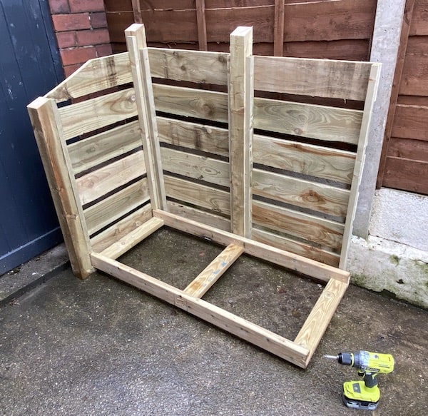 The second back panel is attached, now you slide the base panel into position and screw this in place