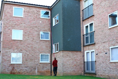 Window cleaning pole with several sections to reach up multi stories