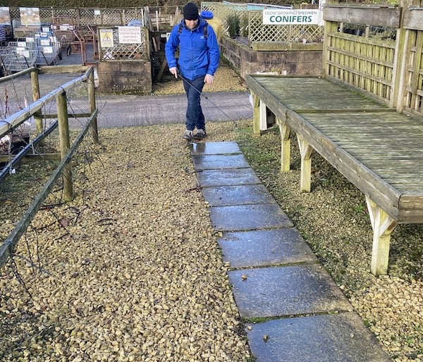 Spraying flagged path with Smartseal Extreme patio cleaner with sprayer