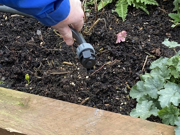 Attaching end stop onto end of water system flexi pipe