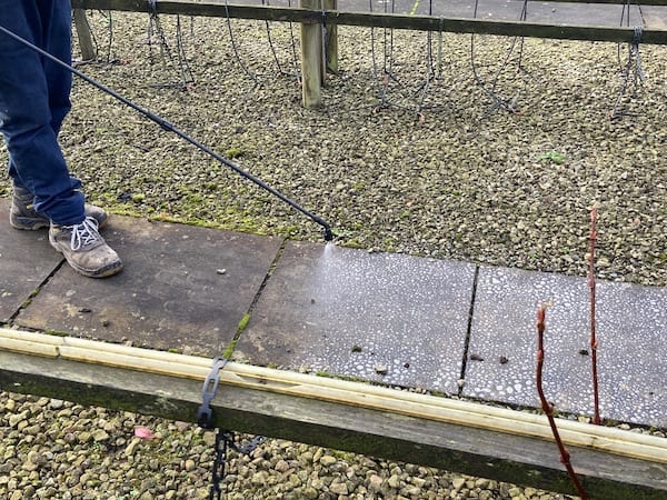 Close up of Ultima plus-xp being applied with sprayer for comparison with Smartseal Extreme patio cleaner