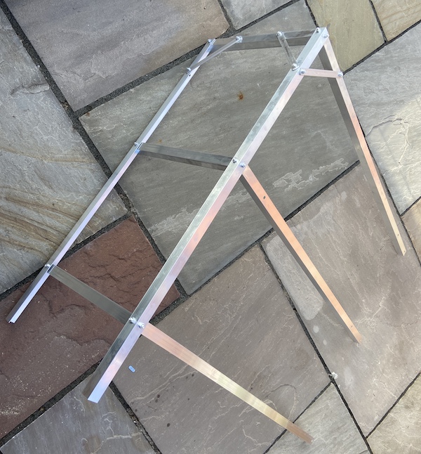 attaching back sections of Tibshelf Garden Products Greenhouse Staging during assembly