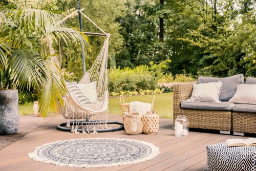 Garden rug placed under swing chair on outdoor decking area
