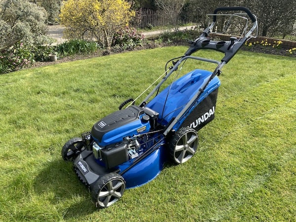 Hyundai HYM510SPE 196cc Self-propelled Petrol Lawnmower which is a good choice for mowing longer grass as it has a powerful 196cc engine plus has 4 speeds for better control on long wet grass and a large collection bag so can collect more  clippings than most other models