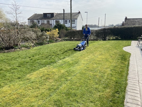 Mowing large lawn with a professional lawn mower model to test and see how well it cuts and collects