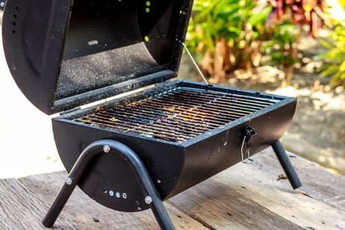 Table top BBQ after some cooking on a wooden table