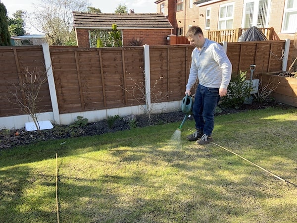 Using a 10 litre watering can mixed with 100g of iron sulphate to water 10 square meters to kill moss
