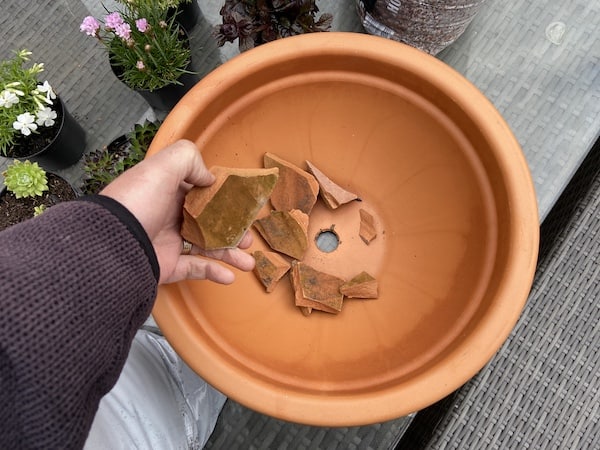 Adding crockery to planter to stop the drainage holes becoming blocked