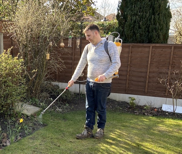 Spraying lawn with Hozelock backpack sprayer with Sulphate of iron to kill the moss on the lawn