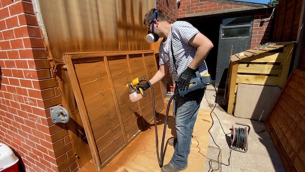 spraying fence panels during testing with Wagner electric fence sprayer