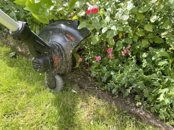 The strimmer head has been rotated 90 degrees and the wheel helps keep it nice and straight