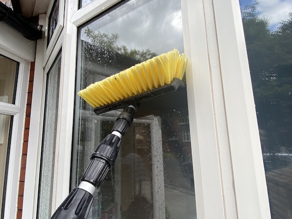 Using window squeegee to leave windows streak free
