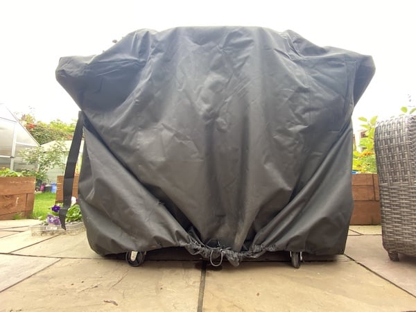 Sotor cover has a drawstring around the bottom to pull the cover tight but also help keep the bottom of the cover off the ground and not get trapped in the wheels