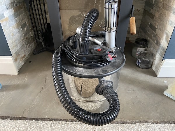 Using a vacuum to clean up wet spills as well as dirt and ash