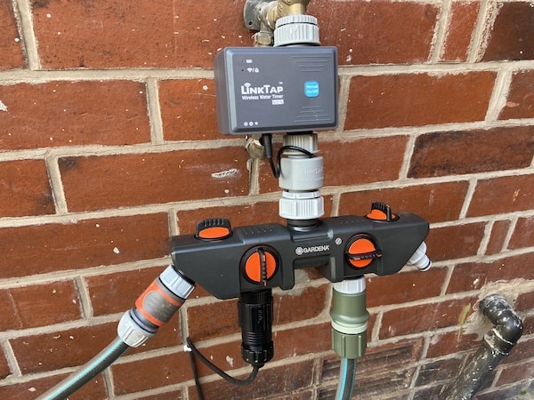 my water timer with a 4-way splitter attached, the left is for the auto hose reel, the middle is for drippers in my pots and the right is connected to sprinklers in my raised beds