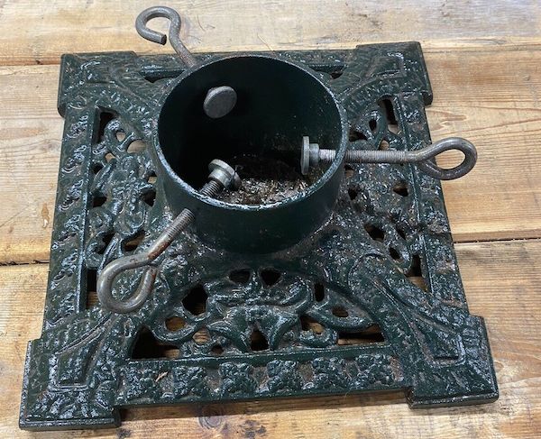 Cast iron stand, great to look at but a nightmare to get the tree to stand straight in and  a very limited space for water