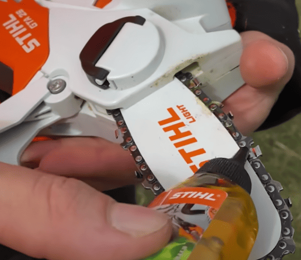 Oiling the chain on the Stihl GTA 26 mini chainsaw