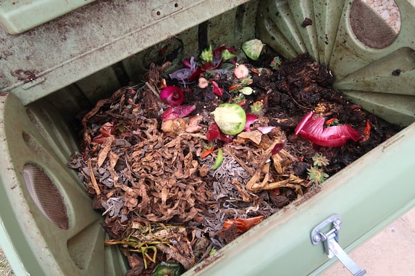 Adding waste to a compost tumbler